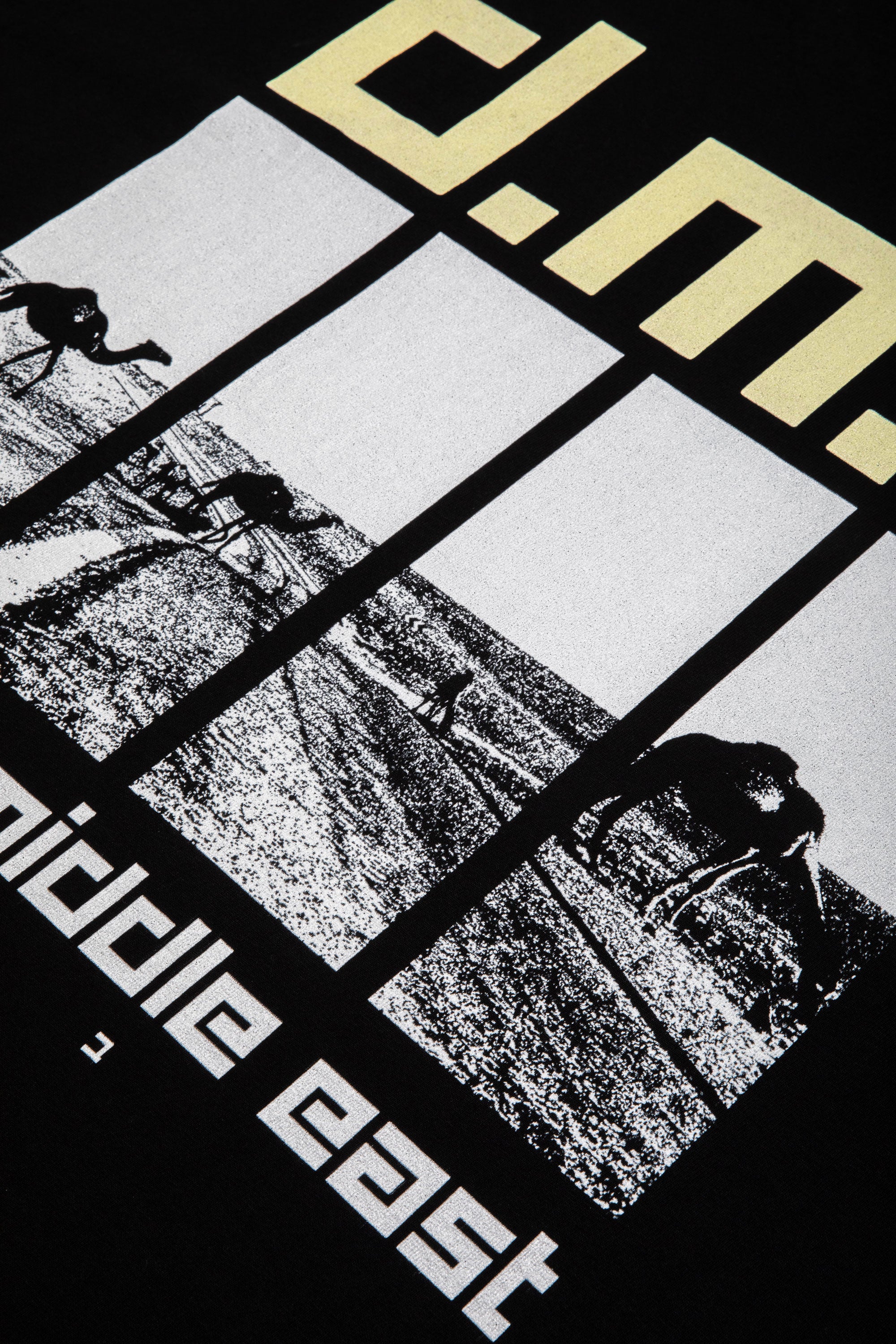 Close-up of the soft cotton texture and graphics on a black oversized t-shirt by DABUSH.
