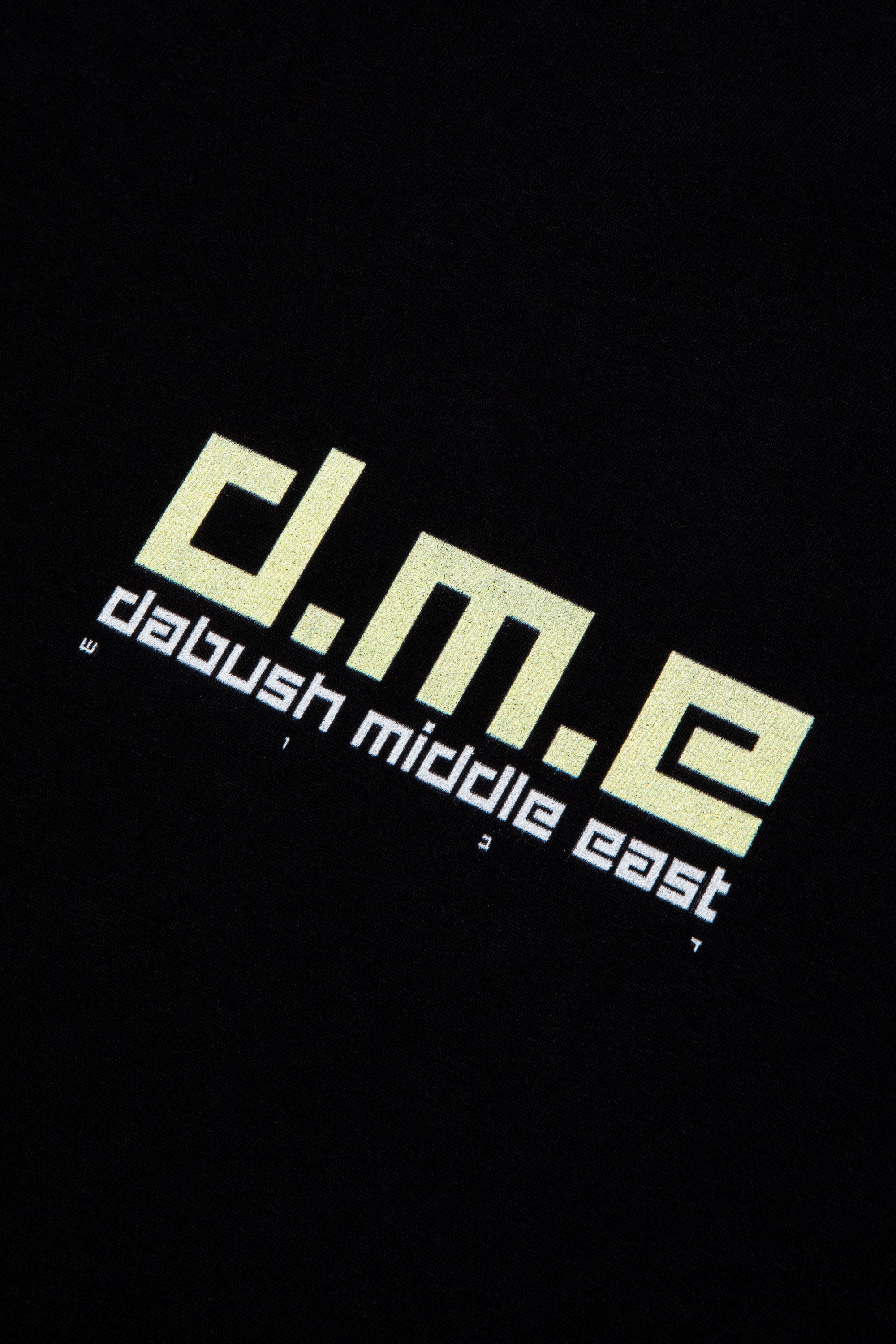 Close-up of the soft cotton texture and graphics on a black oversized t-shirt by DABUSH.