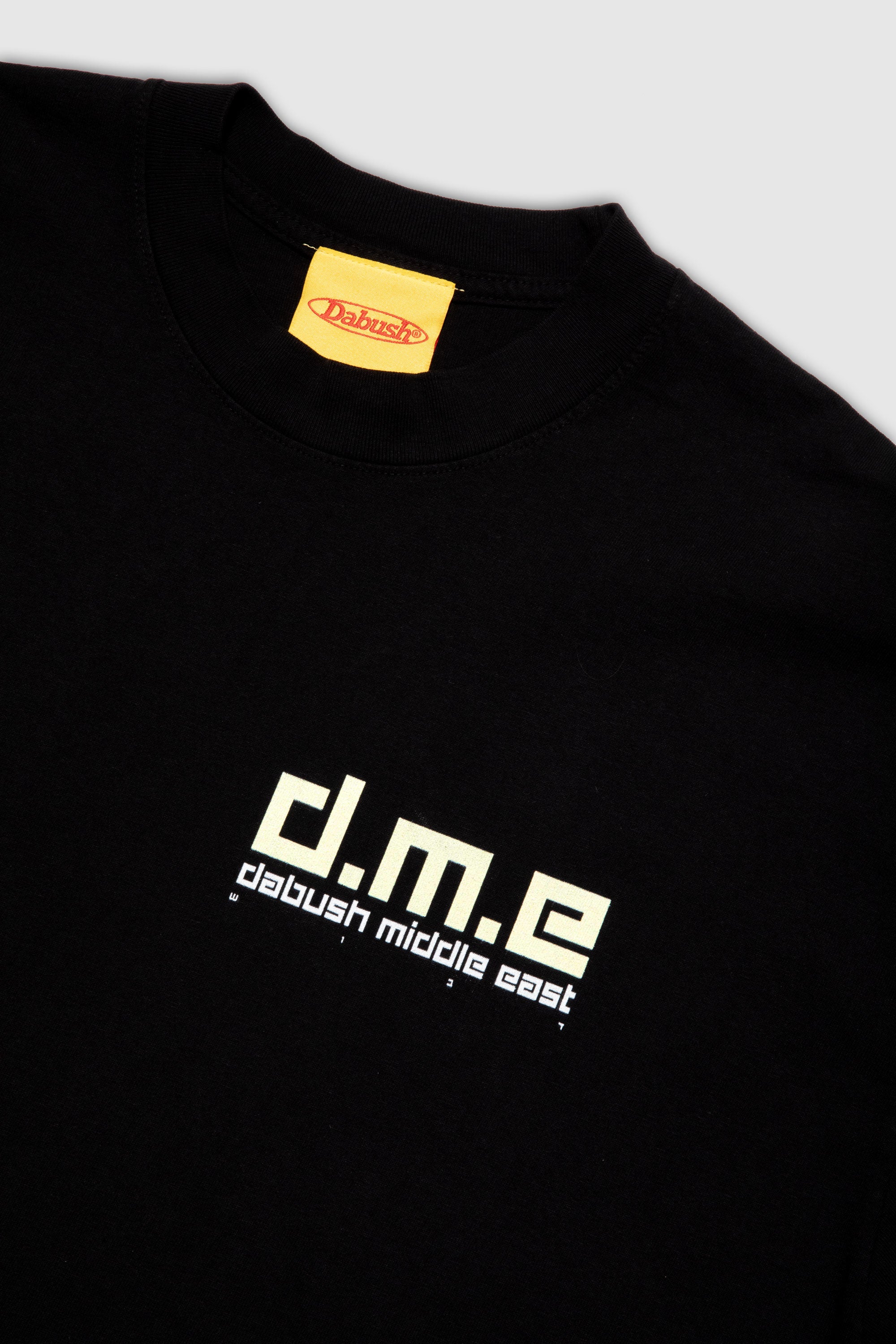 Close-up of the soft cotton texture and graphics on a black oversized t-shirt by DABUSH.