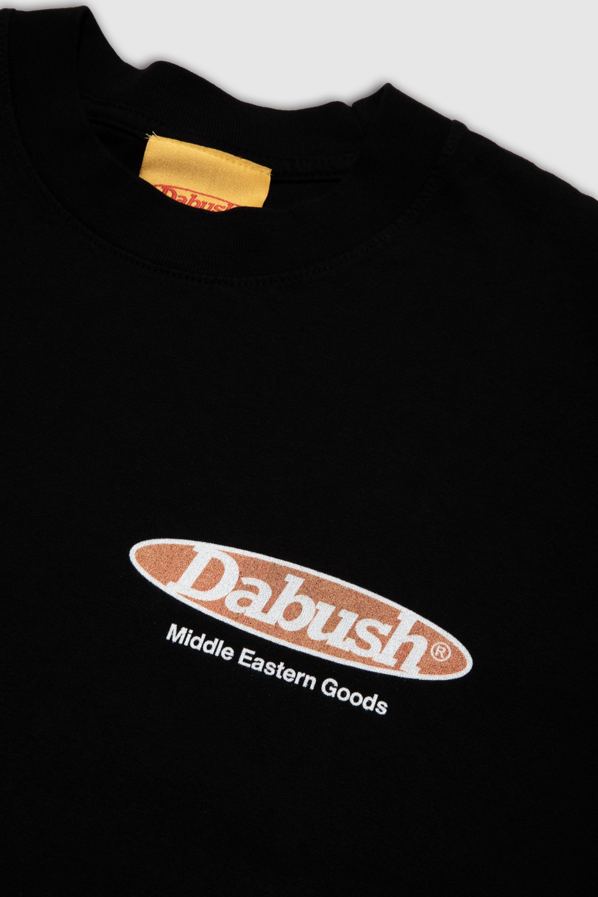 Close-up of the soft cotton texture and graphics on a black oversized t-shirt by DABUSH.